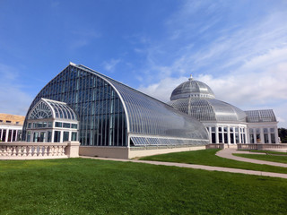 Fototapeta na wymiar Beautiful botanical garden greenhouse with manicured lawn - landscape color photo
