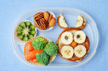 school lunch box for kids with food in the form of funny faces