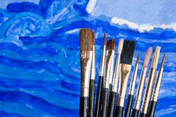 Illustrator paintbrushes on blue watercolor draw background