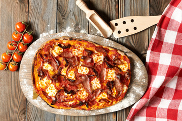 Home made pizza on wooden table