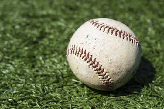 Close-up of baseball on green turf