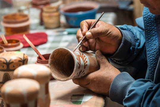 Peruvian Artisan painting a typical peruvian vase