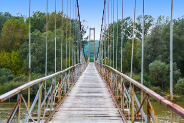 Fototapeta na wymiar Old wooden suspension bridge