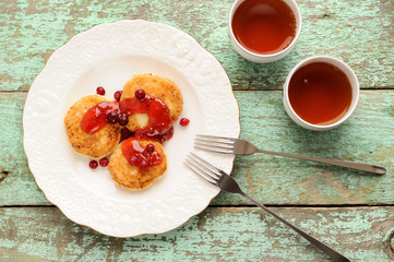 Homemade syrniki, Russian cottage cheese pancakes with raspberry