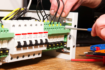 Elektriker Verschrauben Kabel in Verteiler