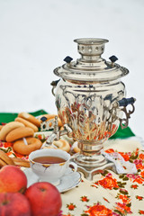 samovar and cup of tea on a colored background