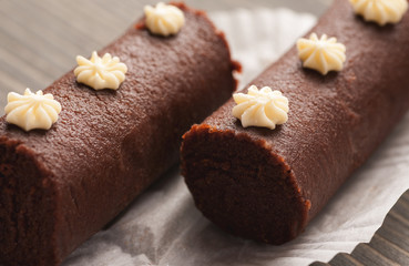 Couple of brown biscuit cakes on a white decorative paper