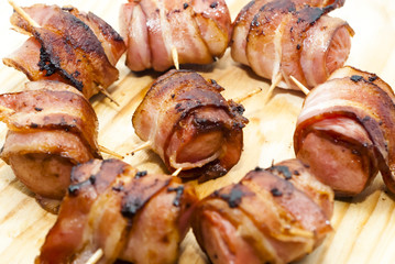 Deep fried sausages rolled in bacon