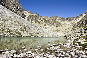 Dlhe pleso lake in high part of Velicka dolina valley with peaks around and clear sky in summer High Tatras mountains © honza28683