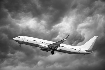 Fototapeta premium Plane at takeoff, the plane on background of clouds