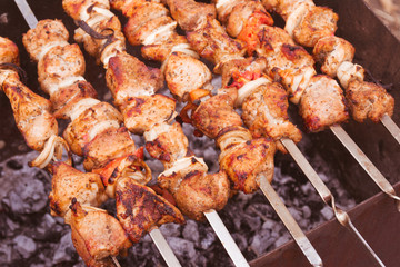 Barbecue meat over the coals