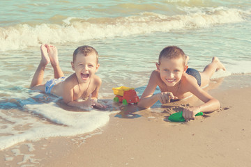 Happy  Children - two boys having fun on the beach