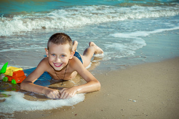 Happy  little boy having fun on the beach