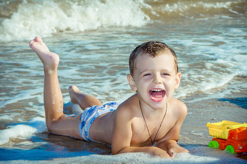 Happy  little boy having fun on the beach