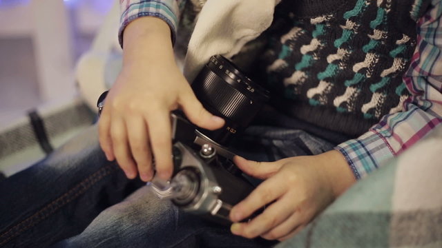 Little boy with old camera
