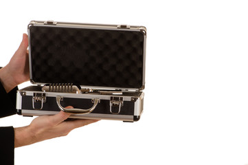 hands of the man hold an open metal case with a microphone
