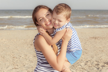 Mother and her son having fun on the beach