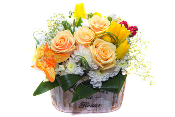 
The composition of flowers , roses, chrysanthemums , tulips in a pot on a white background