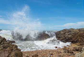 Waves wash ashore during a beautiful rock