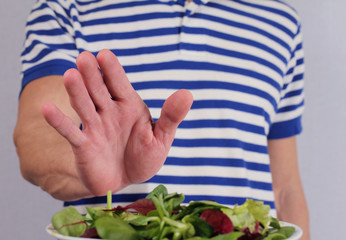 Man refuses to eat salad vegetables