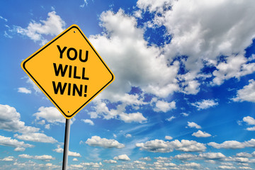 Blue cloudy sky and yellow sign