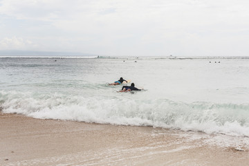 Fototapeta na wymiar Two girls surfers