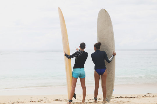 Two girls surfers