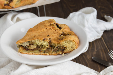 Piece of Pie With Cabbage on Wooden Background.