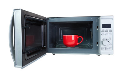Microwave oven with a red cup. Isolated on white with a clipping