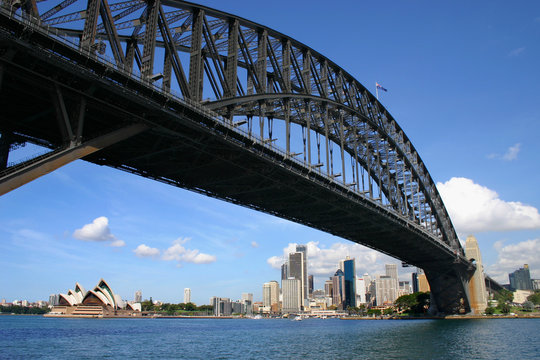 Sydney Australia harbour bridge looking up from under with opera house and financial district in the distance