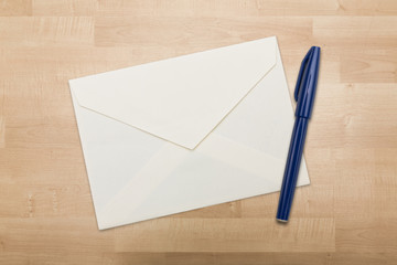 Envelope and blue pen