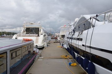 Entrance on pier with moored yachts and boats
