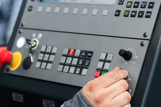 operating the controls of CNC machine