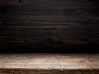 Foto op Plexiglas houten tafel en donkere houten wand © Mara Zemgaliete