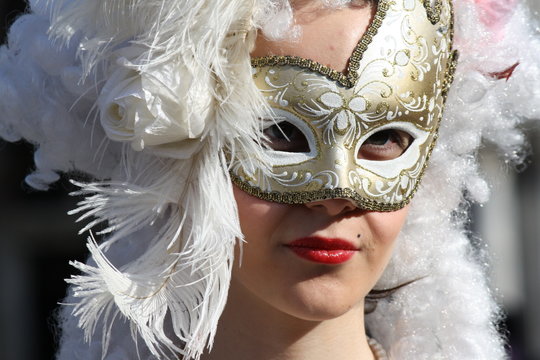 carnival mask in venice posing in san marco square