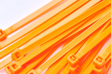 Orange cable ties. Commercial photo on white background.
