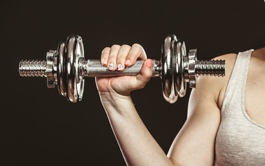 Closeup arm strong woman lifting dumbbells weights