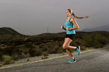 Fototapeta premium young fit sport woman running outdoors on asphalt road in mountain fitness workout