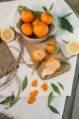 Mandarins and lemon on wooden table