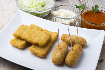 croquettes balls and different kind of sauces on a plate on a cl