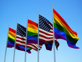 Rainbow flags waving in the wind with a blue sky background. 3d illustration