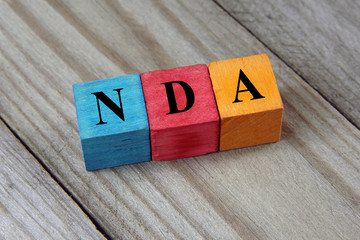 NDA (Non-Disclosure Agreement) text on colorful wooden cubes