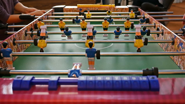 Father and child play kicker table football soccer. Baby-foot game. 4K UHD video footage.