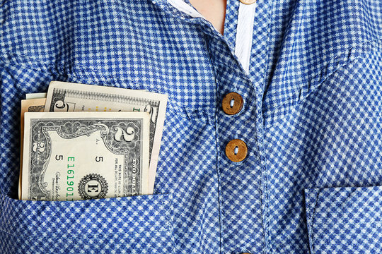 Money in cotton shirt pocket, close up