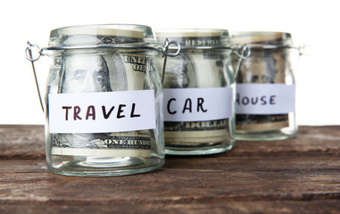 Three jars for different needs full of banknotes