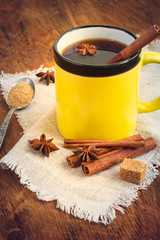 Hot black tea with cinnamon in a ceramic mug. Tinted.