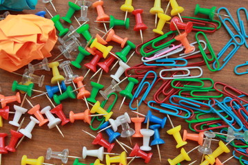 Paperclips, Tacks, Paper Wads on wood background