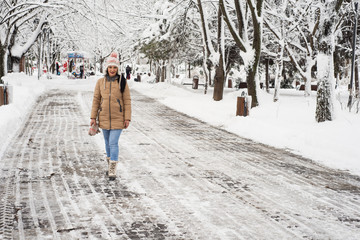 Woman walking in  park with snow