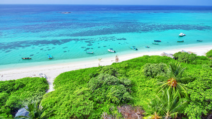 Shoreline of a tropical island in the Maldives and view of the I