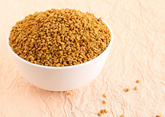 Fenugreek seeds in a bowl.